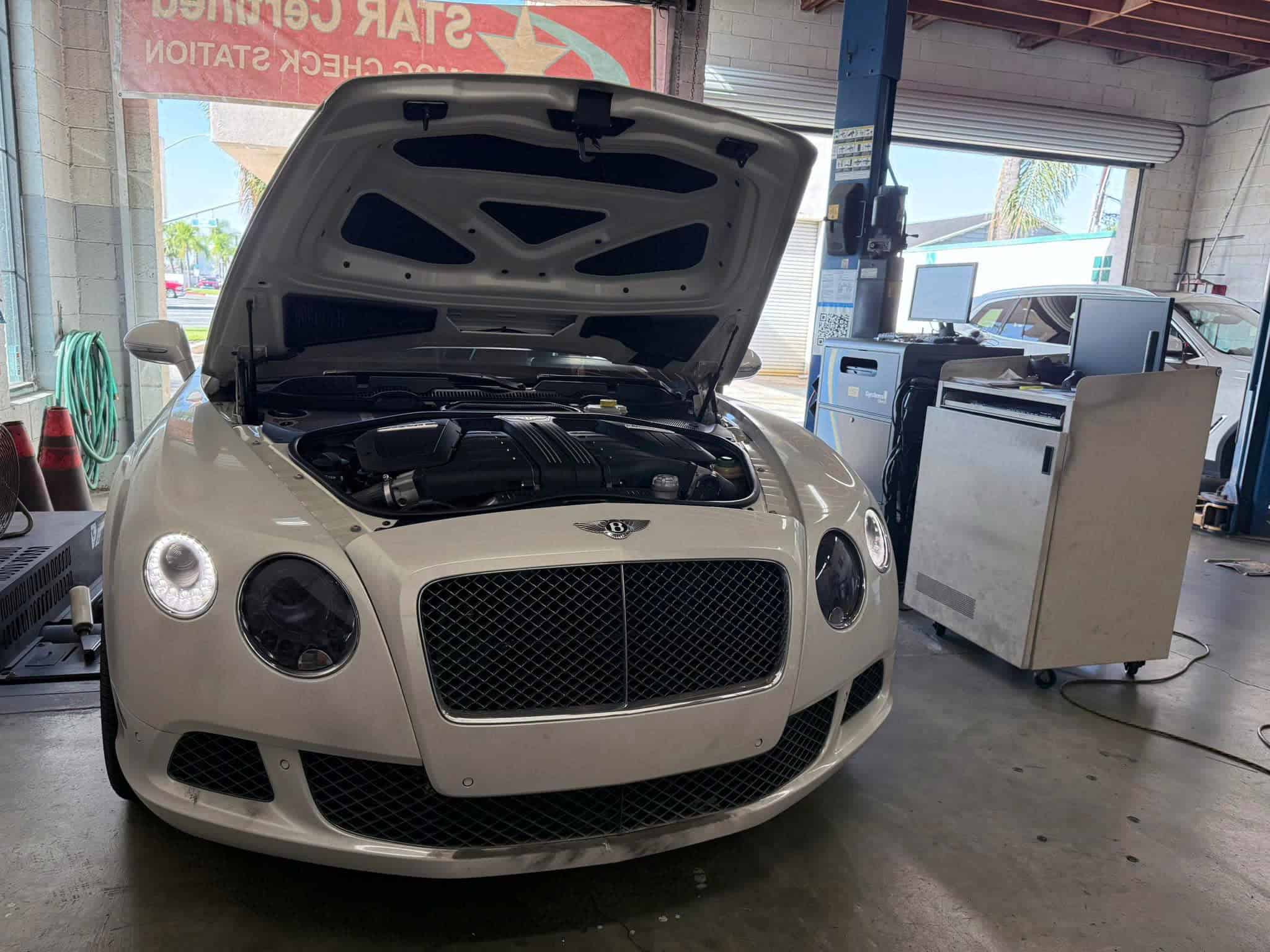 Car undergoing smog check at Vu & Vu Smog Check Test Only Center.